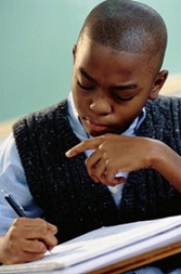 spelling exercises - student writing at his desk