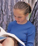 7th grade female student, studying under tree