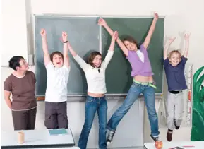 Students jumping with glee at the chalkboard